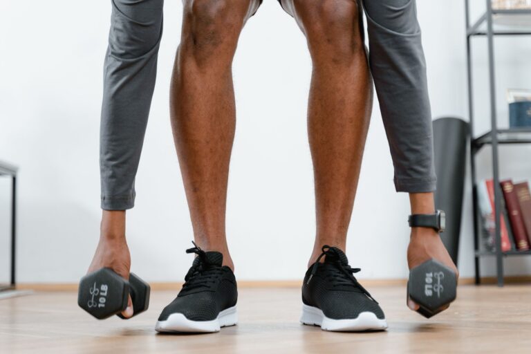 Person lifting dumbbells during a home strength workout